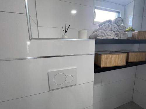 a white kitchen with a sink and a mirror at City house with garden, free parking in Graz