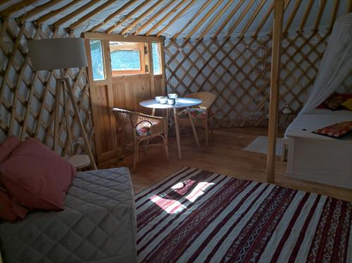 een kamer met een bank en een tafel in een yurt bij Yurta Agricamping Villamagra in Santa Luce