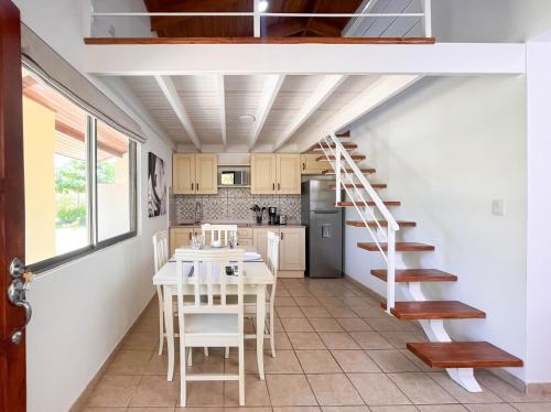 a staircase in a kitchen with a table and chairs at Sueño al Mar Residence & Hotel in Potrero