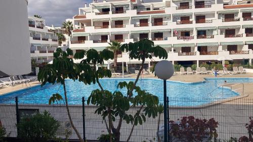 a large swimming pool next to a large building at Victoria Court 2, Los Cristianos in El Guincho