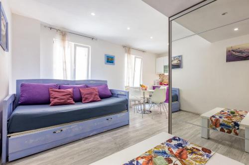 a blue couch in a living room with a mirror at Alpha loft 1BR apartment in center in Zadar