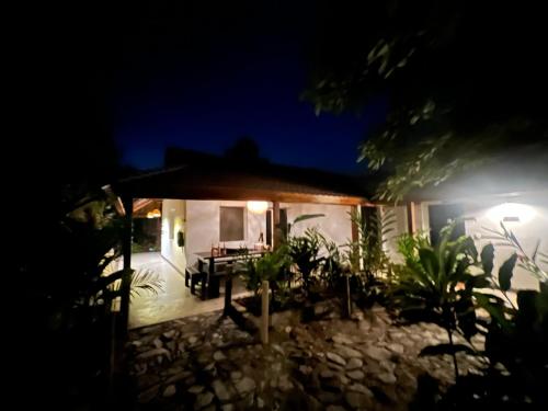 a house at night with a table in the yard at Reserva Natural Tierra Adentro in Minca