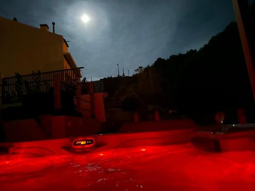 a red light in the dark with the moon in the background at B&C Furnas House in Furnas
