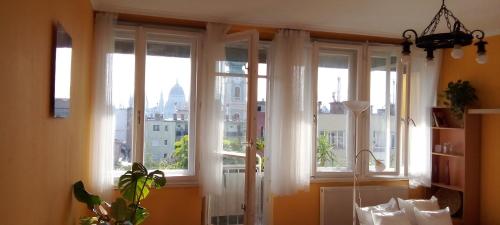 a window with white curtains and a view of a city at Buda Super Panorama in Budapest