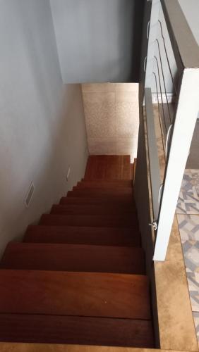 a staircase with wooden flooring and a stair railing at Tropicana Beach & Resort in Elwa