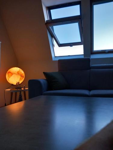 a living room with a couch and a window at Apartment 075 in Tuzla