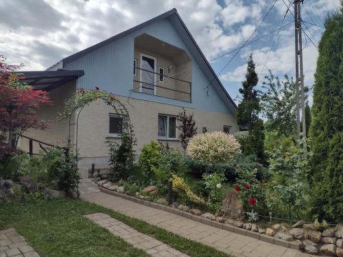 a house with a garden in front of it at Casa Mamei in Suceava