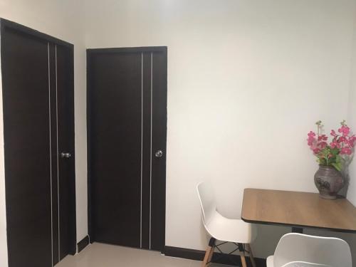 a dining room with a table and a black closet at ONE DD HOMES in Udon Thani
