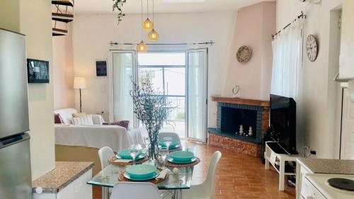 a kitchen and living room with a glass table and chairs at Lake and Sea in Vouliagmeni Lake
