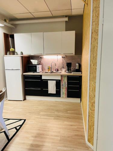 a kitchen with white cabinets and a white refrigerator at Sweet dreams Porvoo in Porvoo