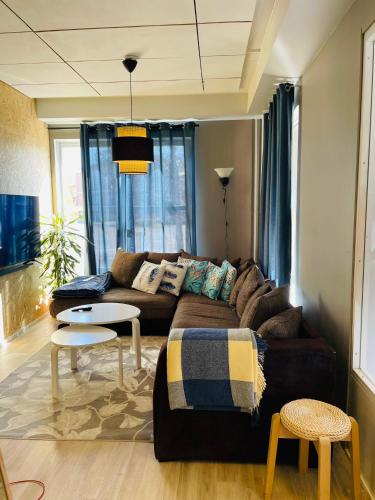 a living room with a couch and a table at Sweet dreams Porvoo in Porvoo