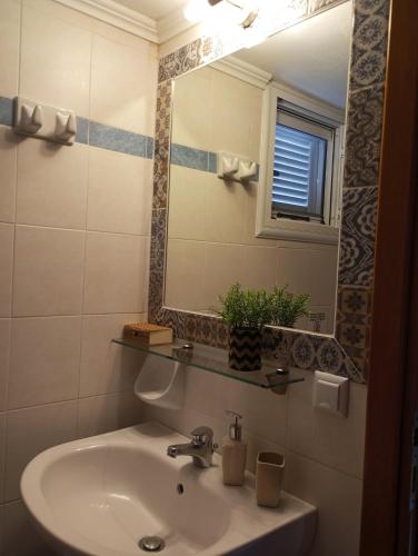 a bathroom with a sink and a mirror at Katerina house in Finikounta