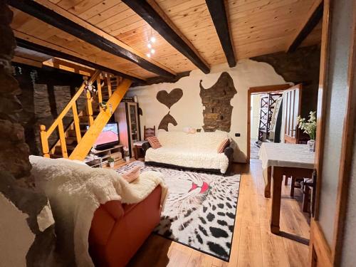 a living room with a couch and a staircase at ANTICA BAITA in Gergei