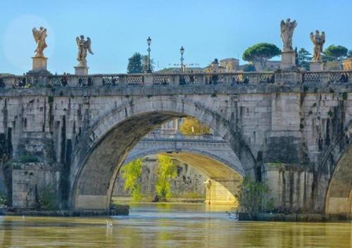 a bridge over the water with statues on it at Air Vatican in Rome