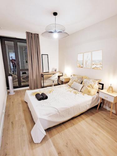 une chambre avec un grand lit blanc et un bureau dans l'établissement Chambre privative dans un appartement intégralement équipé, à Toulouse