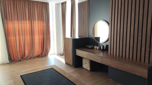 a bathroom with a vanity and a mirror on the wall at Hilal Palace - Halal in Golem