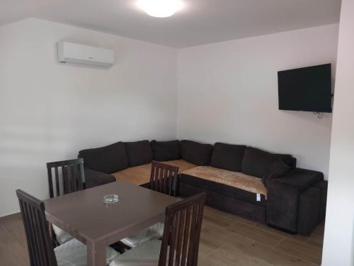 a living room with a couch and a table at PČELICA in Soko Banja