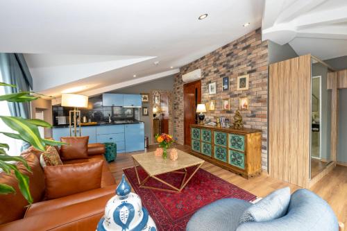 a living room with a couch and a table at The Marions Suite istanbul Special Category Taksim in Istanbul
