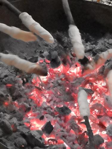 a grill with a bunch of food and fire at Wieserhof Tirol in Oetz