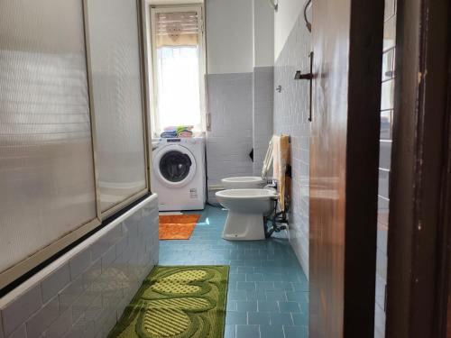 bagno con servizi igienici e lavatrice. di Domus Olimpo a Guspini