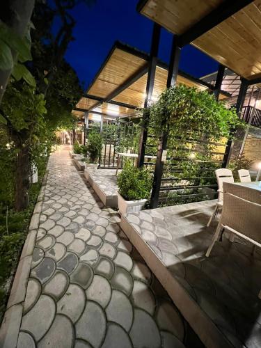 a stone walkway with chairs and tables on a building at Sheki Hilal Boutigue in Sheki