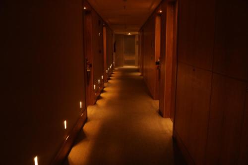 a hallway with a long corridor with lights on it at Flat Premium Particular Cullinan Hotel in Brasilia