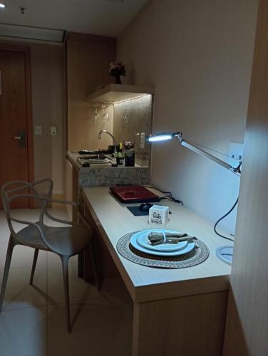 a kitchen with a counter with a plate and a lamp at Flat Premium Particular Cullinan Hotel in Brasilia