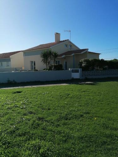 a house with a green yard in front of it at Baleal Atlantic Villa in Baleal