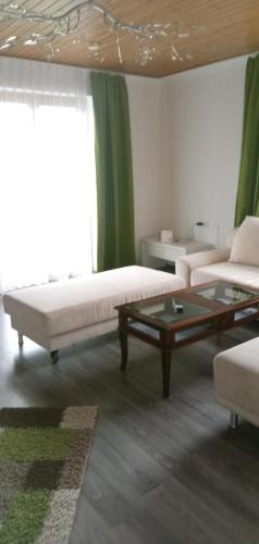 a living room with a couch and a coffee table at Ferienwohnungen Miklautsch in Faak am See