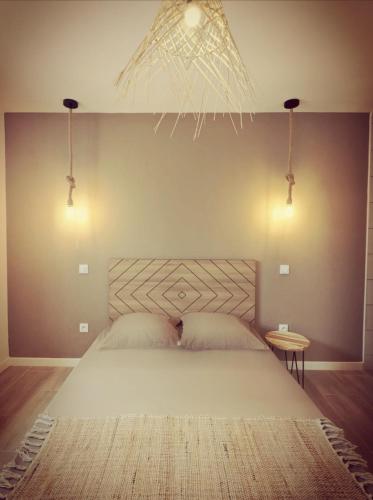 a bedroom with a large white bed with two pillows at Coco in Canet-en-Roussillon