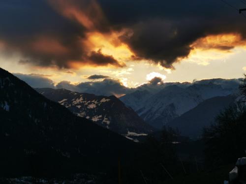 a sunset in the mountains with snow covered mountains at Wieserhof Tirol in Oetz