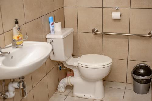 a bathroom with a toilet and a sink at 66 Anglers in Richards Bay