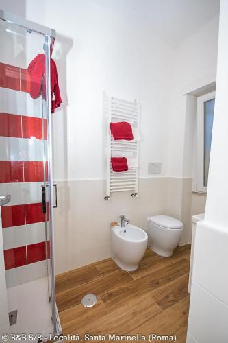 a bathroom with a shower and a toilet and a sink at CINQUE OTTAVI B&B in Santa Marinella