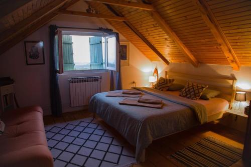 a bedroom with a large bed and a window at Vila Agroturizam Kućica Mostar-Welcome bikers in Mostar