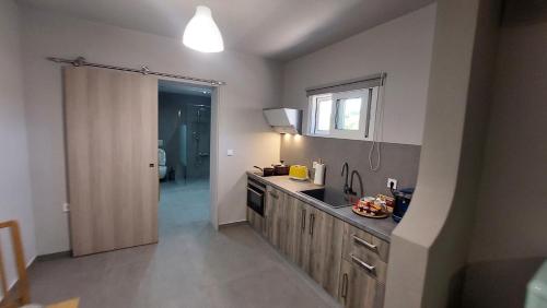 a kitchen with a sink and a counter top at Jimmy's place in Artemida