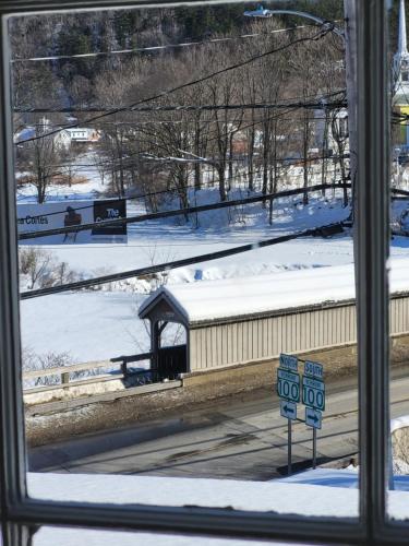 a window with a view of a train station in the snow at The Stowe Village Inn in Stowe