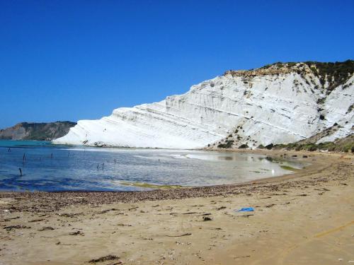 a sandy beach with a white mountain in the background at Punta Grande - Scala dei Turchi in Realmonte