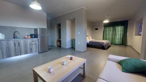 a living room with a couch and a bed at Jimmy's place in Artemida