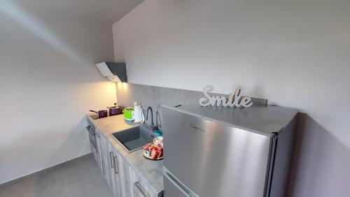 a kitchen with a stainless steel refrigerator and a sink at Jimmy's place in Artemida