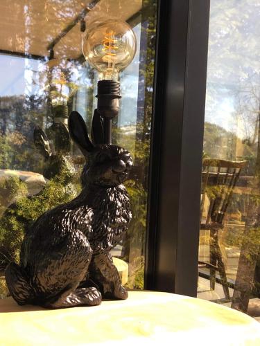 a statue of a rabbit sitting next to a lamp at Vidsyn Midjås in Vistad