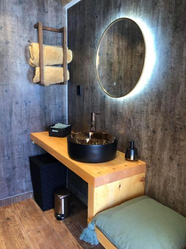 a bathroom with a sink and a mirror at Vidsyn Midjås in Vistad