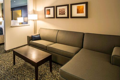 a living room with a couch and a table at Comfort Suites Fort Lauderdale Airport South & Cruise Port in Dania Beach