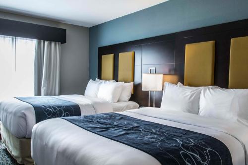 a hotel room with two beds and a window at Comfort Suites Fort Lauderdale Airport South & Cruise Port in Dania Beach