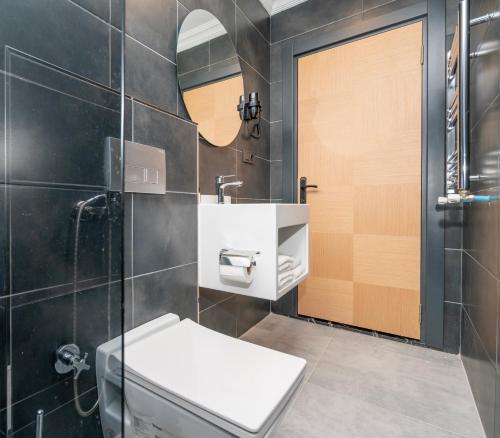 a bathroom with a toilet and a sink at 216 Center Suite in Istanbul
