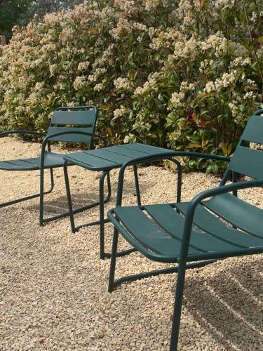 two green chairs and a table and chairs at Le Cabanon de Livia avec piscine privée in Cucuron