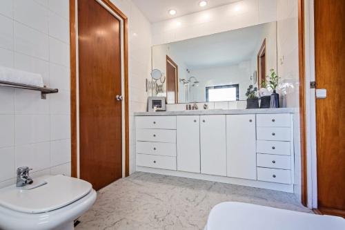 a bathroom with a white toilet and a sink at Sweet Inn - Bogatell Beach in Barcelona