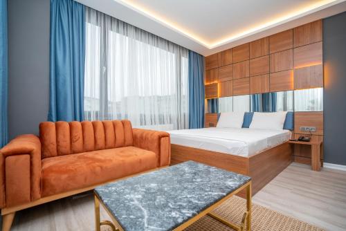 a hotel room with a bed and a couch at Center Suite in Istanbul