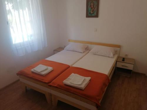 a bedroom with a bed with two towels on it at Villa Sonja apartments in Trebinje