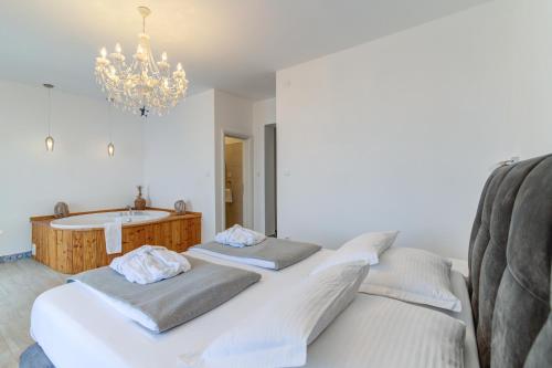 a bathroom with two beds and a bath tub at LUMIN 4 in Senj