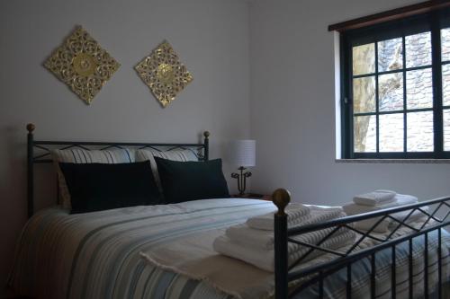 a bedroom with a bed and a window at Quinta de São Domingos house in Peso da Régua